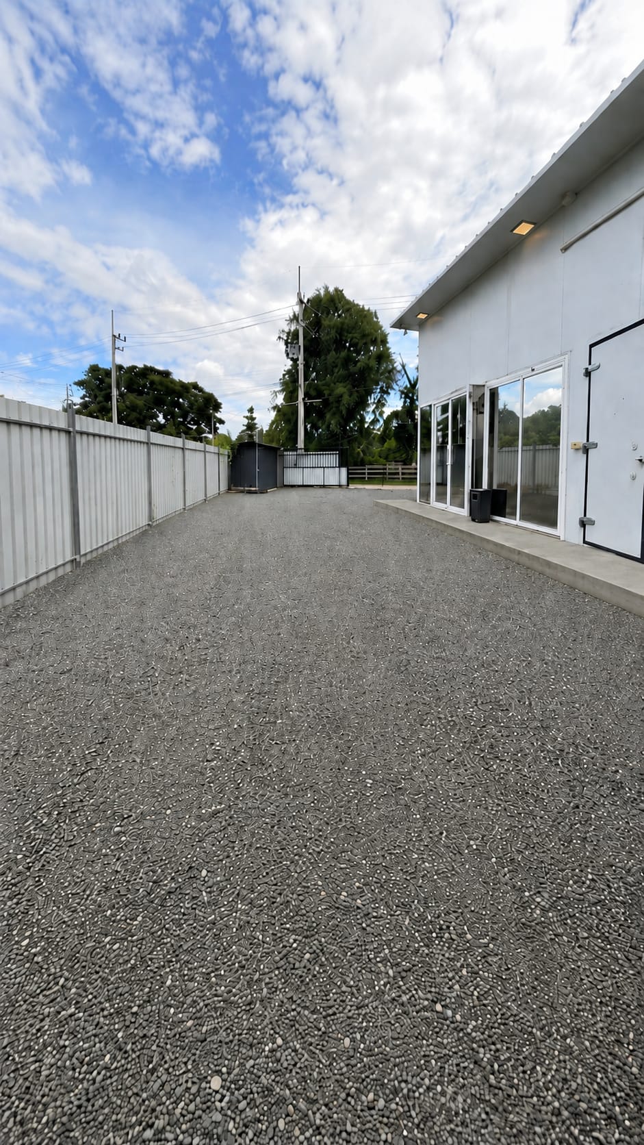 Wide view of the gravel yard beside the modular building