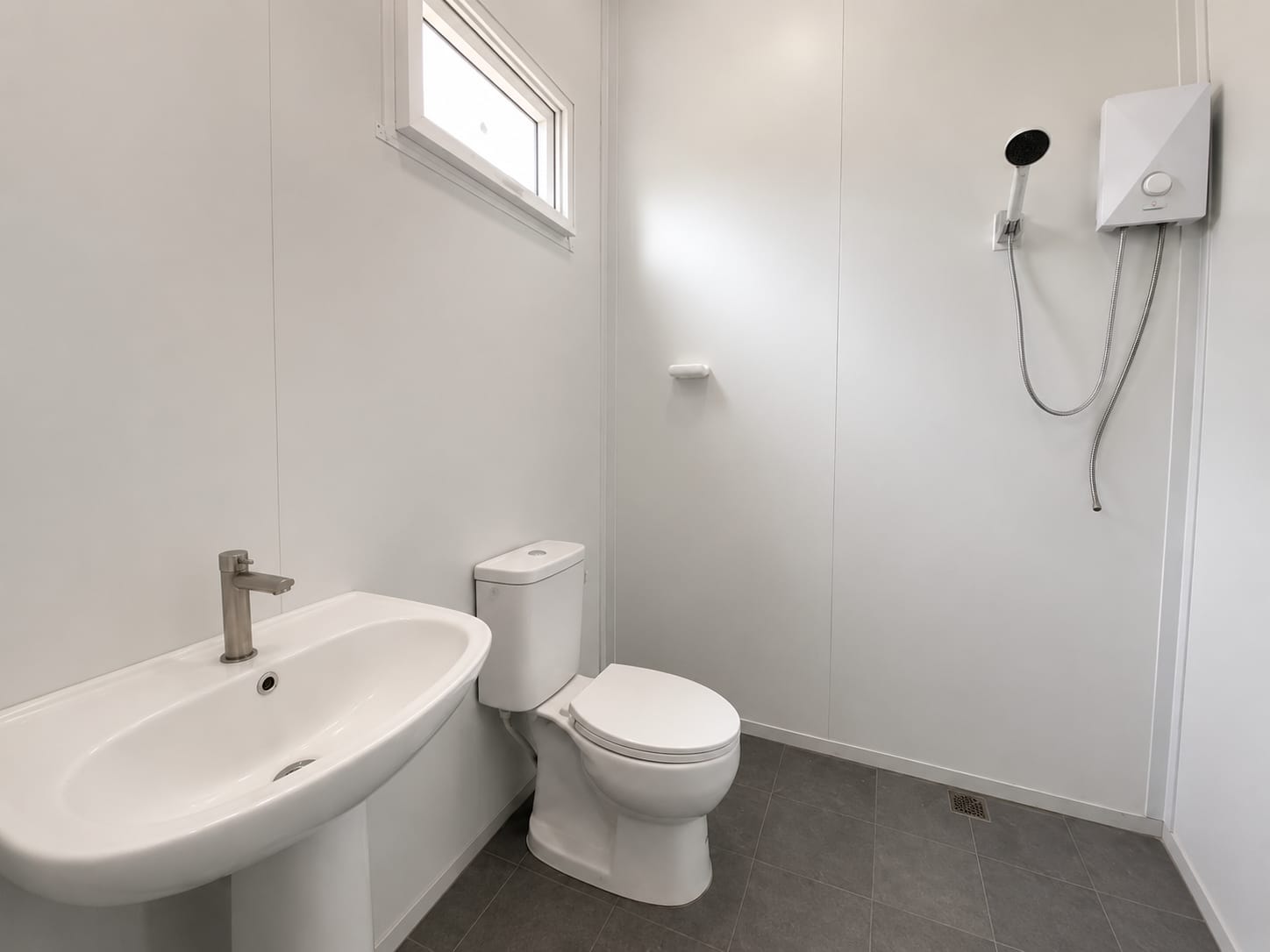 Finished bathroom with toilet, sink and shower