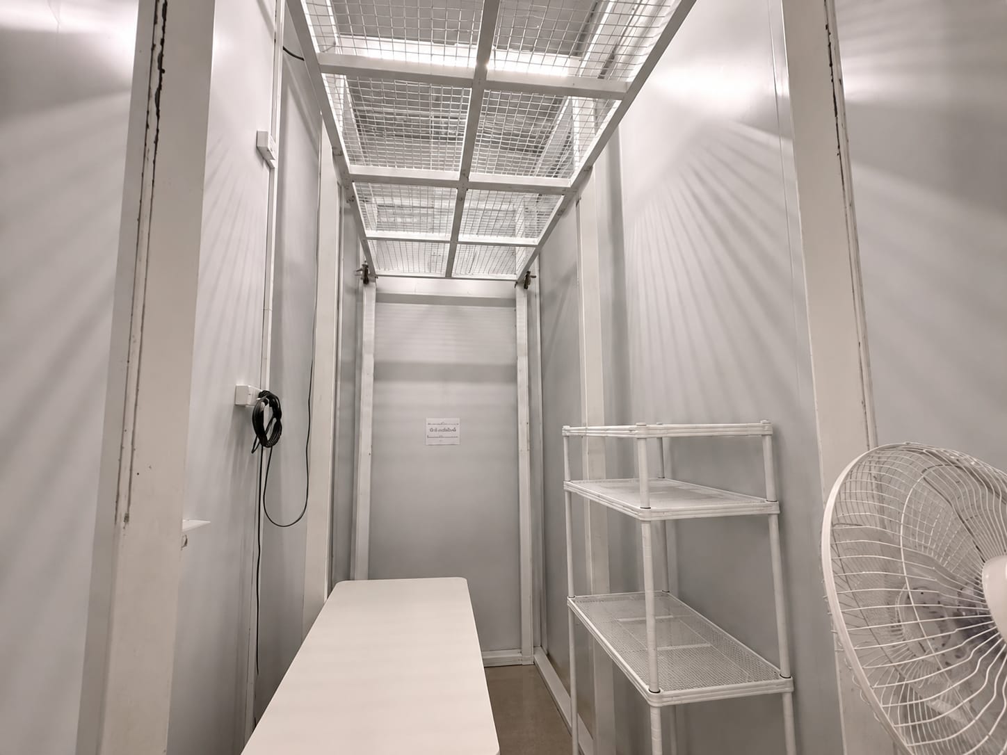 Narrow storage and utility room with shelving