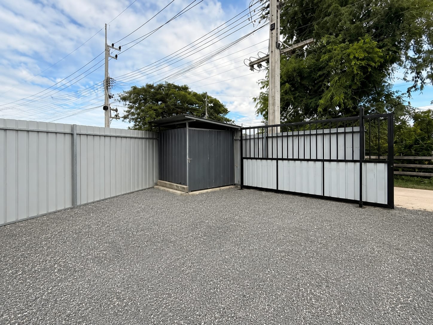 Gravel storage yard with shed and gate
